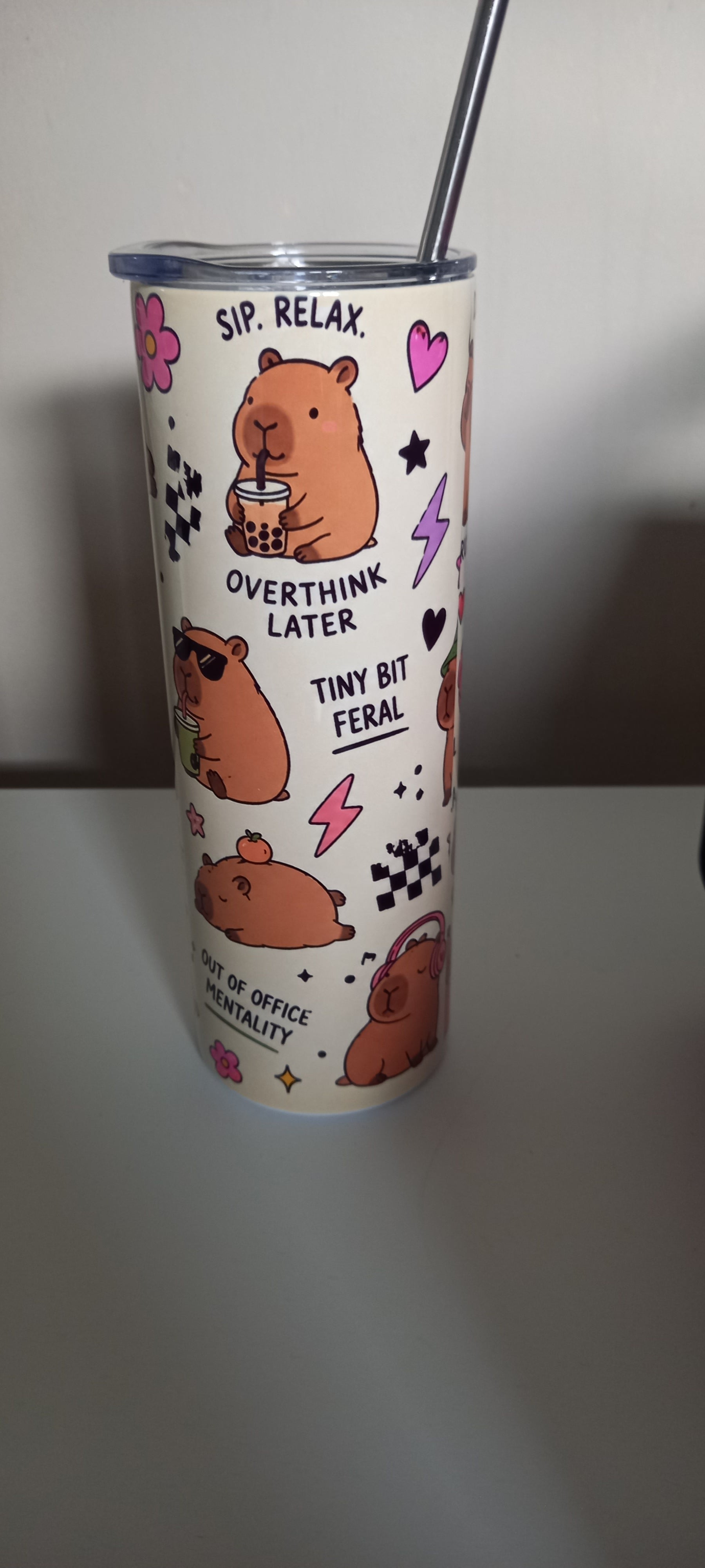 Capybara tumbler side view showing Sip Relax Overthink Later, Tiny Bit Feral and Out of Office Mentality