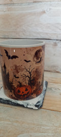 Halloween ceramic mug with pumpkin, bats and full moon design on earthy brown background