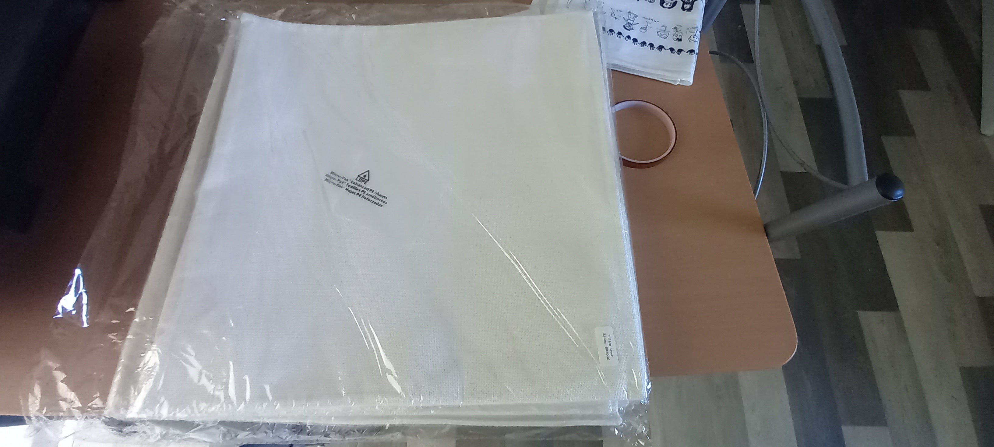 Personalised cushion cover in packaging